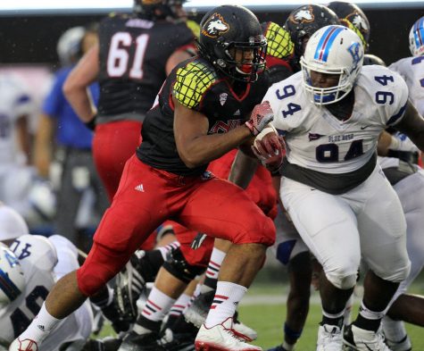 Sophomore tailback Joel Bouagnon (28) blocks a Presbyterian defender Thursday at Huskie Stadium. Bouagnon made his first career start at running back in the Huskies’ 55-3 victory over the Blue Hose, taking 16 handoffs for 97 yards and four touchdowns, including his first career rushing touchdown.