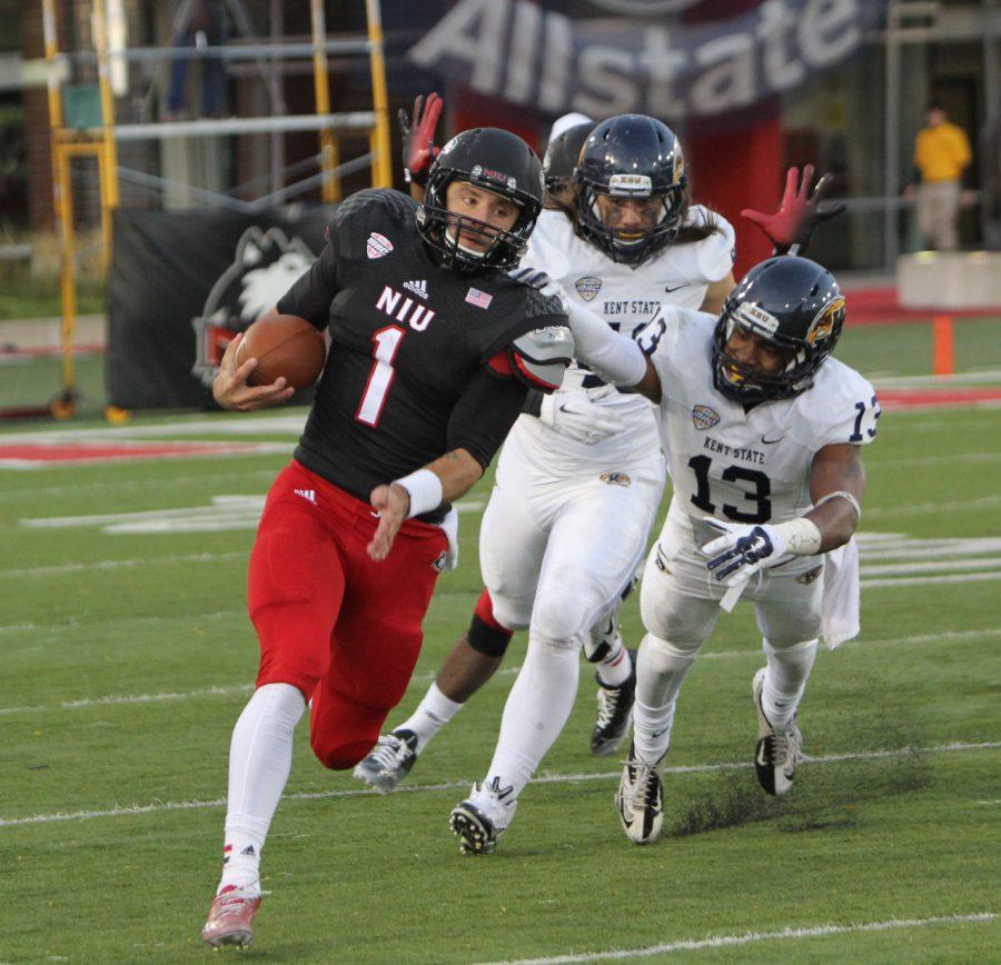 Redshirt sophomore quarterback Anthony Maddie (1) rushes for a 20-yard gain against Kent State Saturday at Huskie Stadium. Maddie led NIU’s only two touchdown drives and reopened the debate over who should be NIU’s quarterback.