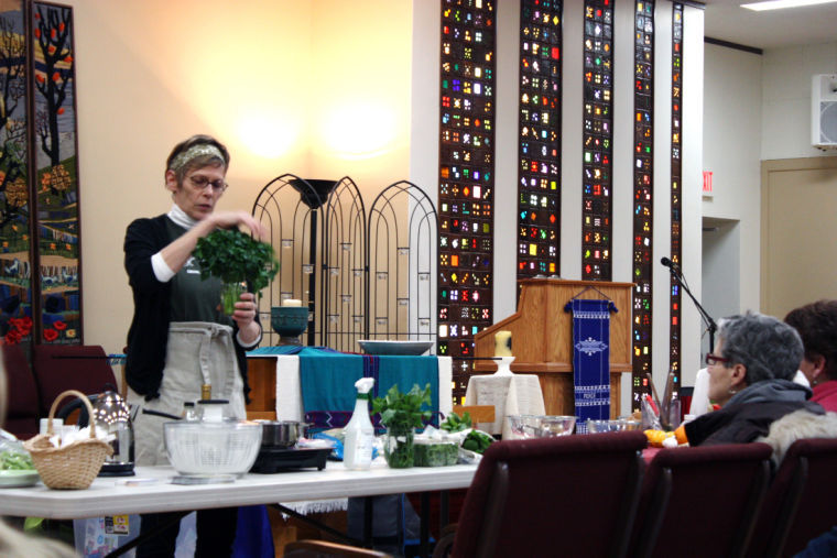 Jo Cessna, culinary instructor with KishHealth Systems, gives a demonstration on how clean, store and cook early spring greens at a DeKalb County Community Gardens meeting. The meeting — the first of the year — was Tuesday at the Unitarian Universalist Fellowship, 158 N. Fourth St. Meetings are the first Monday of every month.