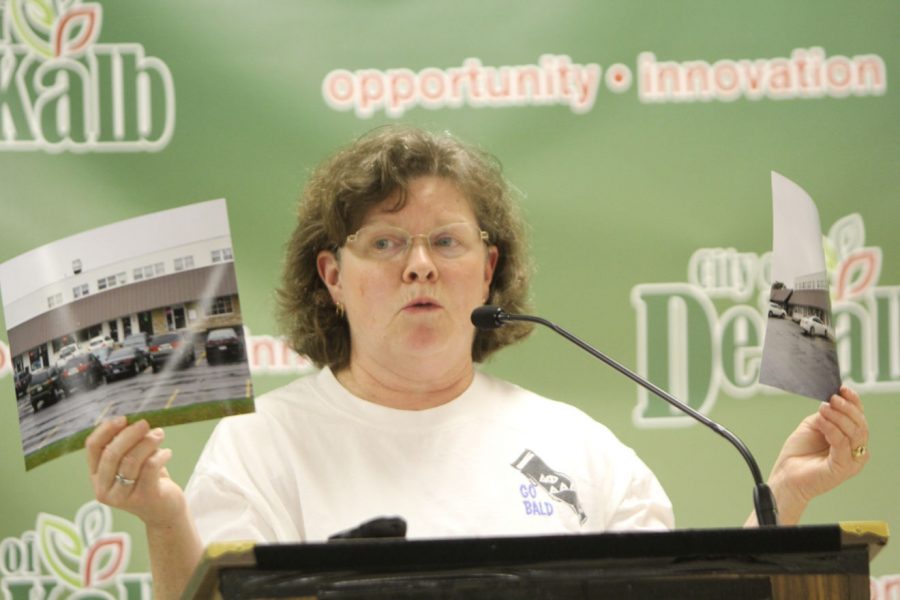 Diane DeMers, resident of the Ellwood Historic Neighborhood, expresses her concerns over the implementation of a enterprise zone in DeKalb at a Monday City Council meeting in the DeKalb Municipal Building. DeMers brought photographs of a strip mall at the corner of Annie Glidden Highway and Hillcrest Drive to show attendees what an enterprise zone could create in the Ellwood Historic Neighborhood. An enterprise zone is an area within a community where companies receive incentives, including tax credits and exemptions.