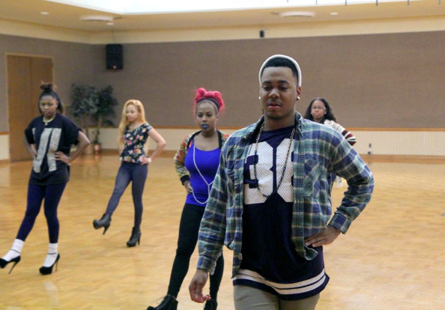 Anthony Sampson, Present Perfect Modeling Organization choreographer and junior communication major, leads student models during their rehearsal Nov. 16 in the Holmes Student Center’s Regency Room.