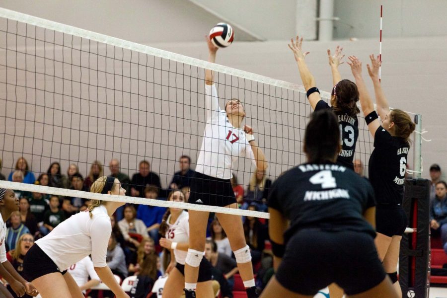 Lauren Zielinski (17), redshirt sophomore middle blocker, spikes the ball Saturday at Victor E. Court in the match against the Eastern Michigan Eagles. The Huskies’ 3-2 loss to the Eagles was their first loss in DeKalb since Aug. 30.