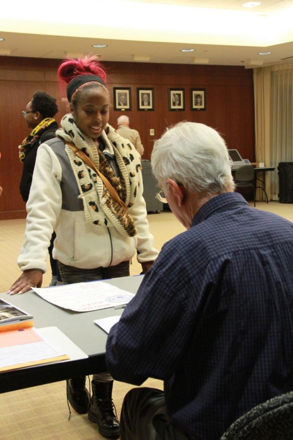 Senior biology major Tymeka Branch collects her ballot from election judge Toney Xidis Tuesday at the Barsema Alumni and Visitors Center.
