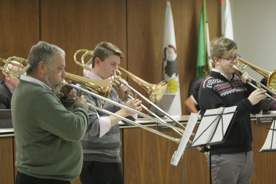 Members of the DeKalb Municipal Band perform a Christmas song Monday at the City Council meeting in the DeKalb Municipal Building. The DeKalb Municipal Band is celebrating its 160th anniversary, making it the oldest band in the state. The band was invited to City Council to be publicly commemorated.