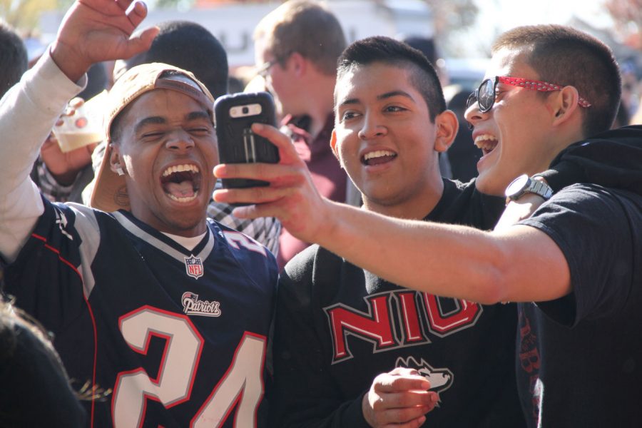 NIU students celebrate Homecoming weekend by tailgating outside of Huskie Stadium Saturday before the football game.