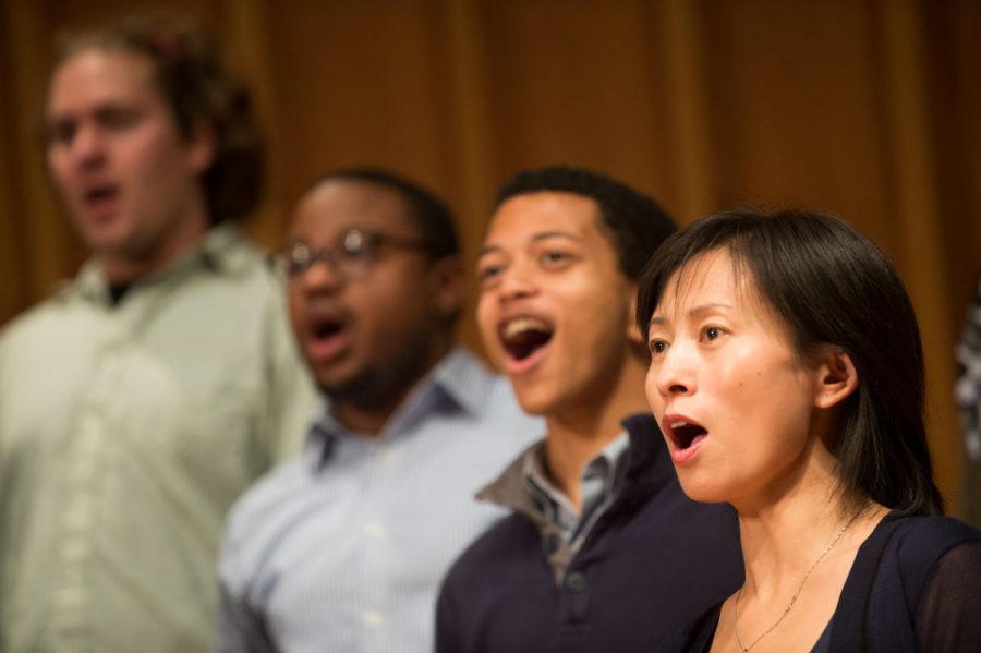 Singers practice during a fall rehearsal in the Music Buildings Boutell Memorial Concert Hall. Students can attend the choral holiday concert 3 p.m. Sunday.