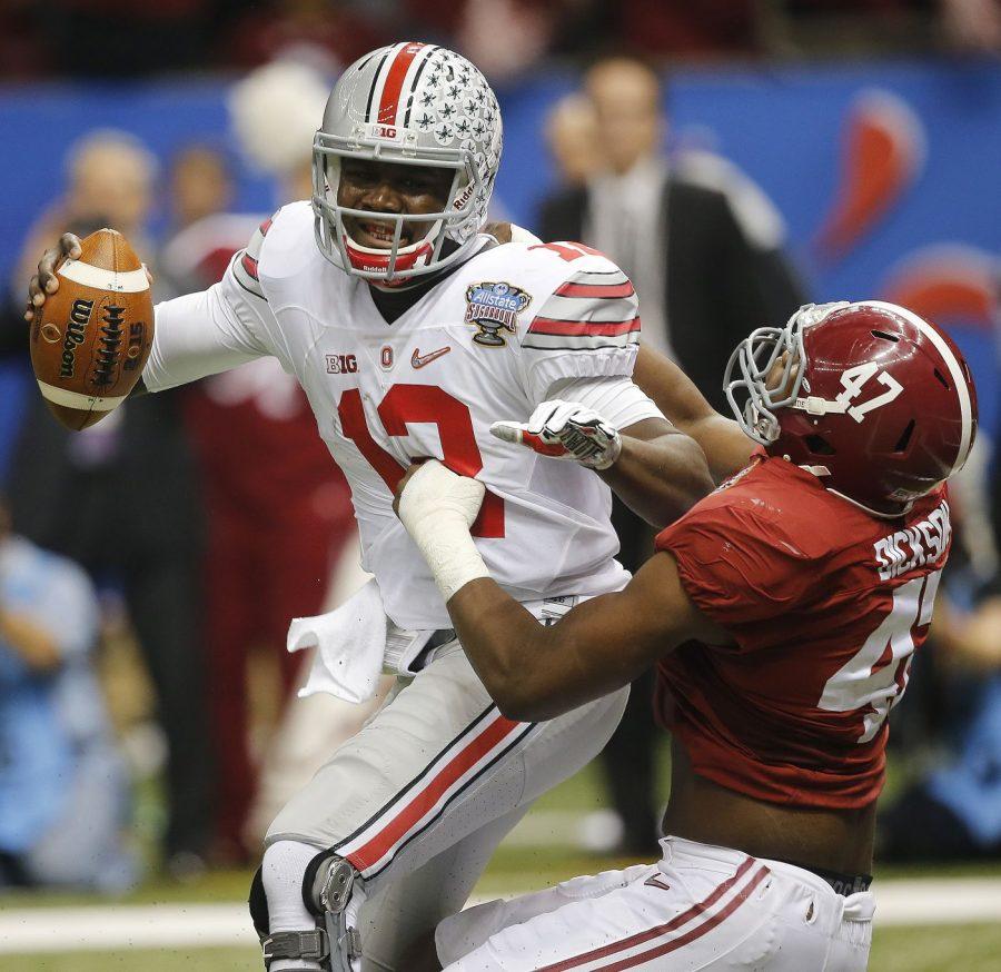 Ohio State quarterback Cardale Jones (12) is sacked by Alabama Crimson Tide line Xzavier Dickson (47) in the Sugar Bowl semifinal game Jan. 1 at the Mercedes-Benz Superdome in New Orleans.