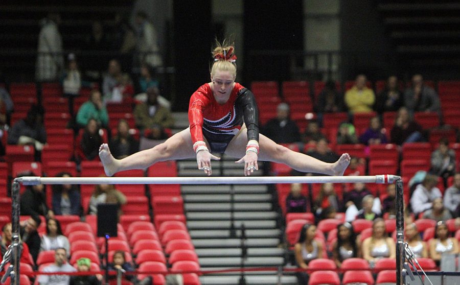 Senior Meg Piepenbrink performs on the bars in the Huskies’ home opener Friday at the Convocation Center in the meet vs. the Kent State Golden Flashes. At 47.825, bars was the lowest score for the Huskies, who out-scored Kent State on vault and floor en route to a historic home victory.