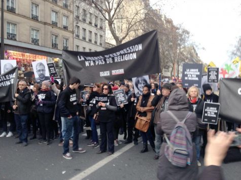 People march in the streets of Paris to show support for freedom of expression in the wake of the Jan. 7 Charlie Hebdo slayings. History professor Brian Sandberg, who was in Paris during the massacre, said he plans to use his experiences when teaching his comparative religious violence class.