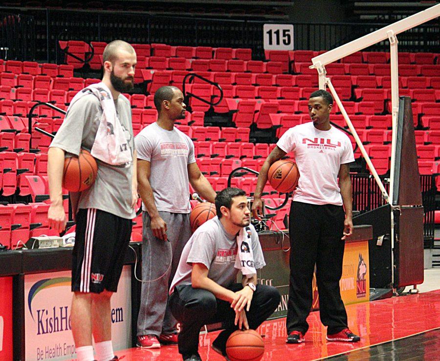 (Left to right) Student-managers Drew Zickert, Kevin Ramsey, Chris MacMartin and Keffer Simpson wait on the sidelines as the team warms up doing running drills. The student-managers work 30-plus hours per week, but it’s their “passion” and “love” of basketball that drives them.