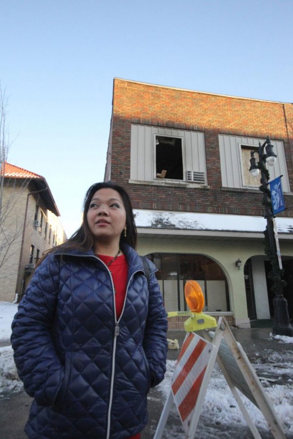 Gladys Sanchez, junior special education major, stands in front of her burned-out apartment building on Third Street. Sanchez and her son, Buddy, 6, lost their home and most of their possessions in a Jan. 7 fire, but the DeKalb community has raised more than $8,000 to help them start over.