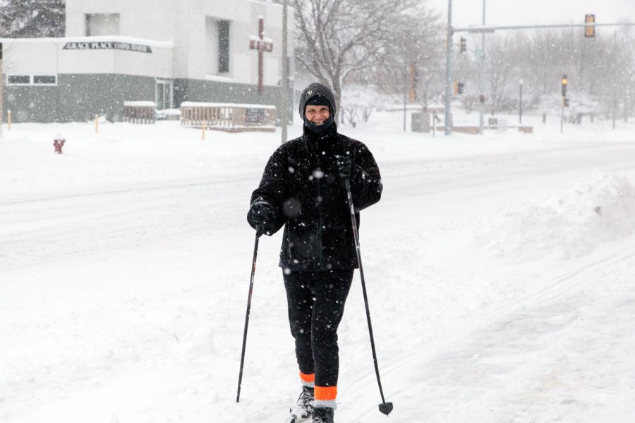 DeKalb resident Kelly Sears makes use of the snowfall Sunday by using skis to get around in front of the Holmes Student Center.