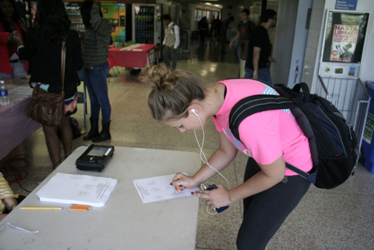 Kelly Iseli, sophomore electrical engineering major, places her vote tuesday for the Student Association Senate at DuSable Hall in September 2013.