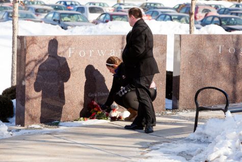 Kaitlyn King (left) and Joe Palmer, recipients of the 2014 Forward, Together Forward Scholarship, lay flowers by Gayle Dubowski’s memorial stone at a ceremony Saturday. The ceremony honored those lost when gunman Steven Kazmierczak killed five students before killing himself on Feb. 14, 2008, in Cole Hall. The scholarship is given to students who best embody the qualities of the shooting victims.