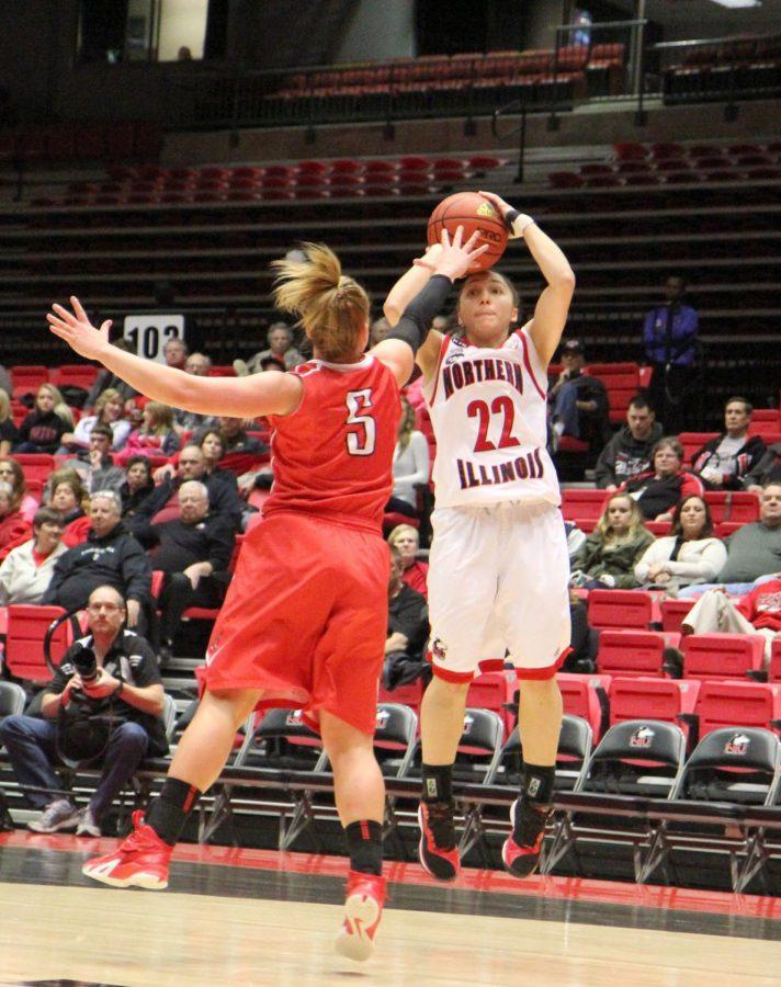 Senior guard Amanda Corral (22) shoots over a Ball State defender Saturday at the Convocation Center. Corral scored 16 points, but her final bucket was waved off as the clock had expired, and NIU lost, 51-50.