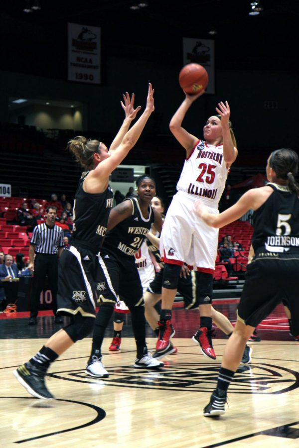 Freshman Kelly Smith (25) shoots the ball over a Western Michigan defender Wednesday at the Convocation Center. The Huskies saw their four-game wining streak come to a close with a 60-51 loss to the Broncos. Now, they hit the road for two games looking to start another win streak.