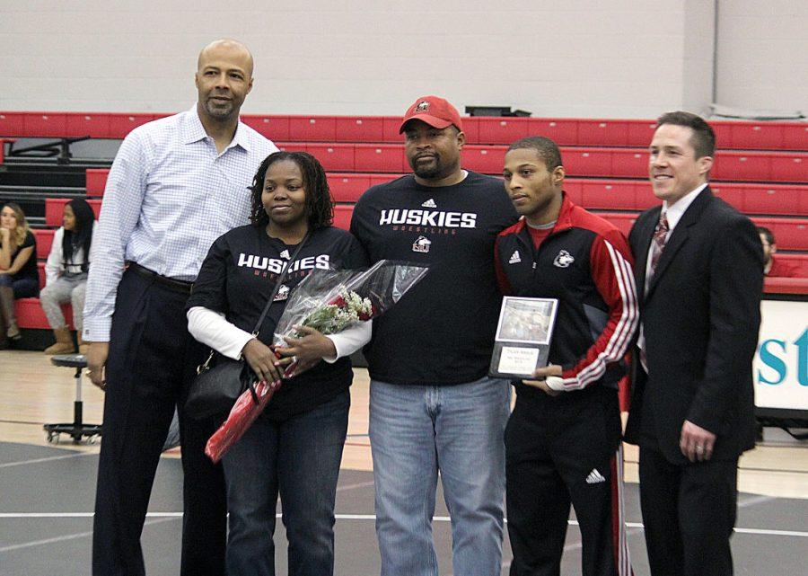 Senior wrestler Tyler Argue (center right) is recognized for his four years at NIU prior to Friday’s dual against the Buffalo Bulls at the Convocation Center. Argue was joined by his dad, David Argue (center), his mom, Monica Argue (center left), and head coach Ryan Ludwig (far right).