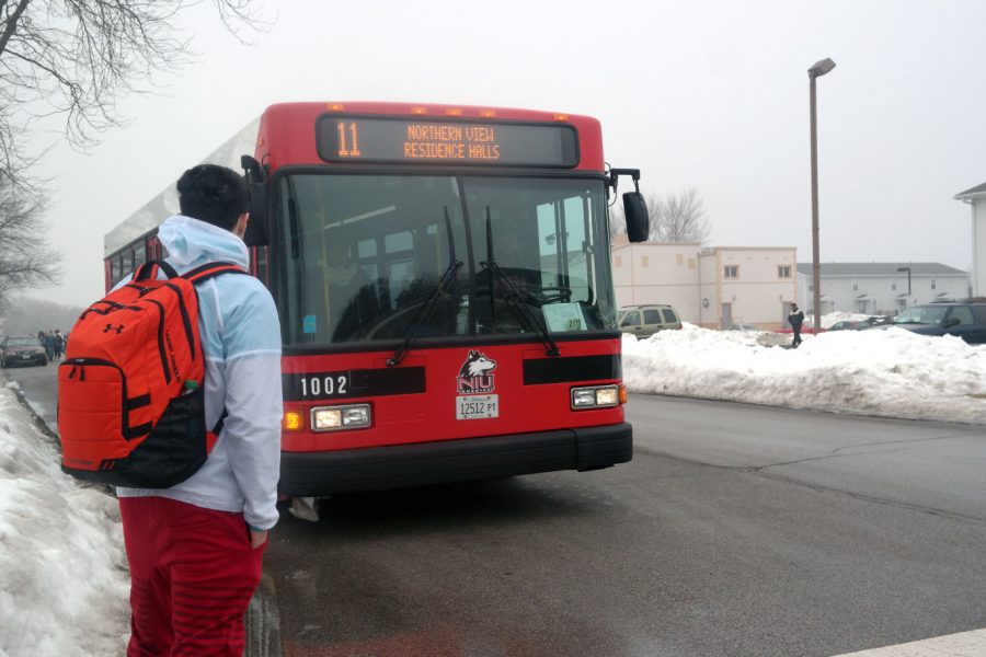 Sophomore kinesiology major Mitchell Rodriguez waits for the No. 11 weekend break circle route bus on Blackhawk Road Sunday. Huskie Bus Line routes will be revamped with input from students who will participate in focus groups. New routes will be introduced in the fall.