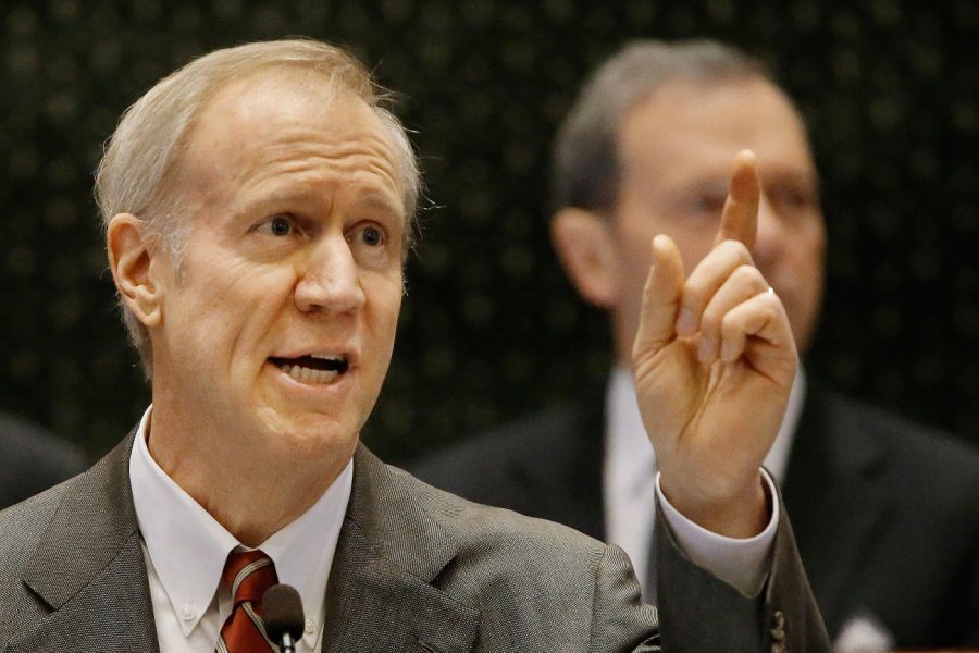 Gov. Bruce Rauner delivers his budget proposal to a joint session of the General Assembly in the House chambers Wednesday in Springfield. Rauner’s proposal calls for a $387 million cut to higher education funding, which would amount to a $29.3 million cut in funding to NIU.