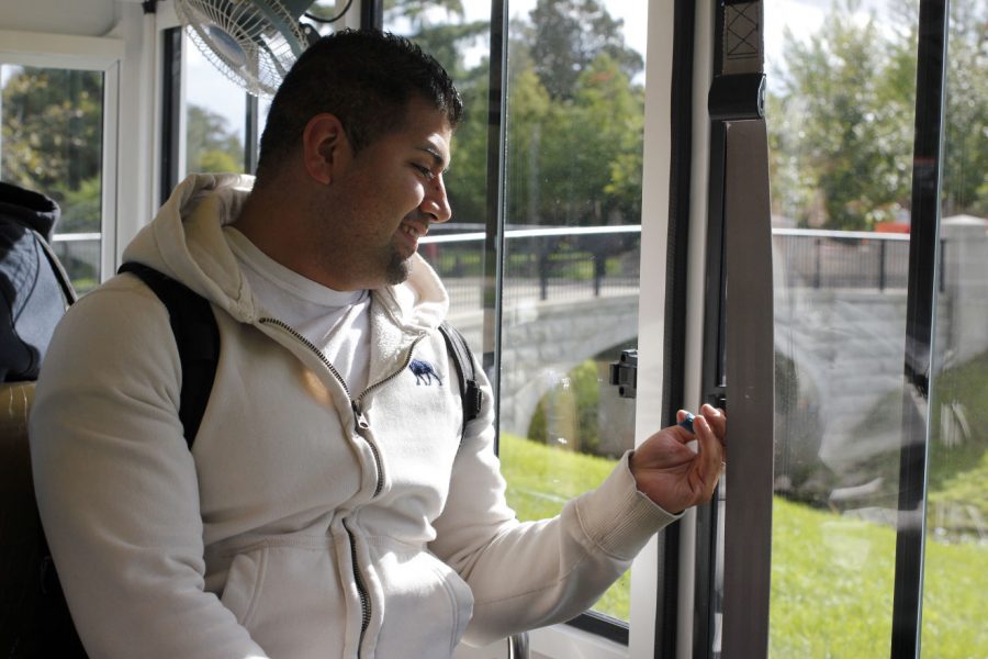 Michael Herrera, senior political science major, looks out the window of the Huskie Pup Bus Oct. 7 as he takes a ride to class. Three Huskie Pups arrived to campus Monday, but they will not be available for students until next week, said Bill Nicklas, vice president of Operations and Community Relations. 