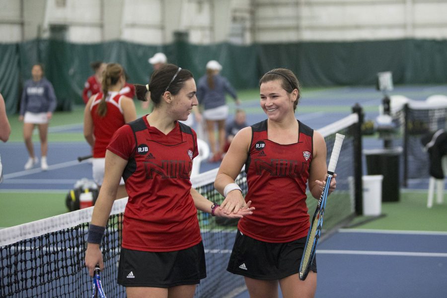 Junior Cristina Alvarez (left) and senior Nelle Youel celebrate after a Jan. 31 win over the Bradley Braves at the Boylan Tennis Center in Rockford. The duo have exploded to a 10-0 start for women’s tennis in their first season together as partners as the No. 1 doubles team.