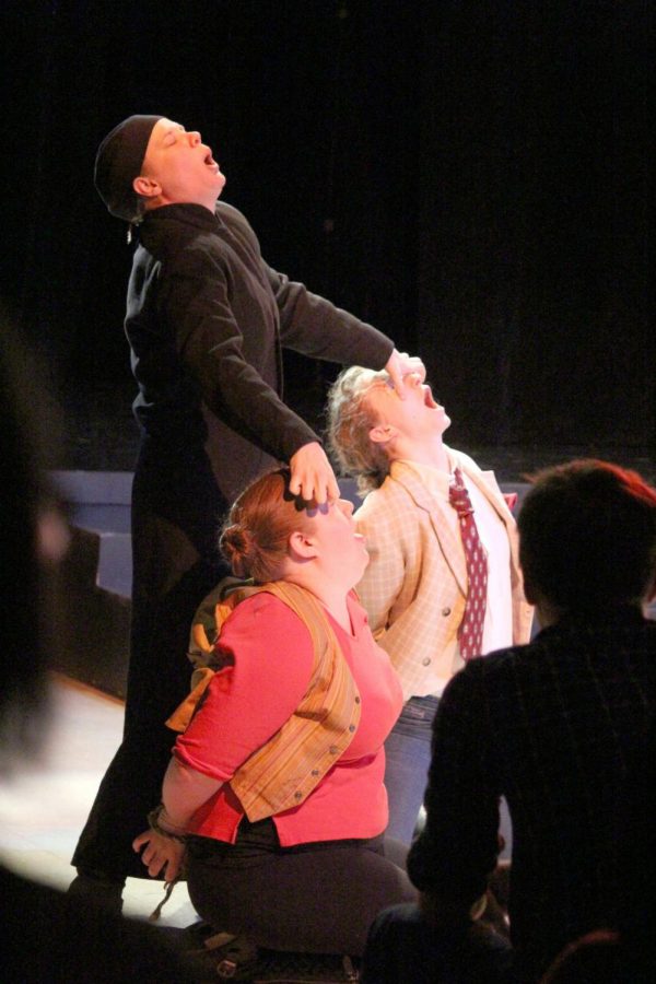 Dr. Pinch, played by Emily Rieder, attempts to unpossess Dromio (left) and Antipholus of Ephesus (right), played by senior acting major Annie Pfohl and master’s acting student Jenni McCarthy, respectively, in “Comedy of Errors” Saturday in the Holmes Student Center, Diversions Lounge. 