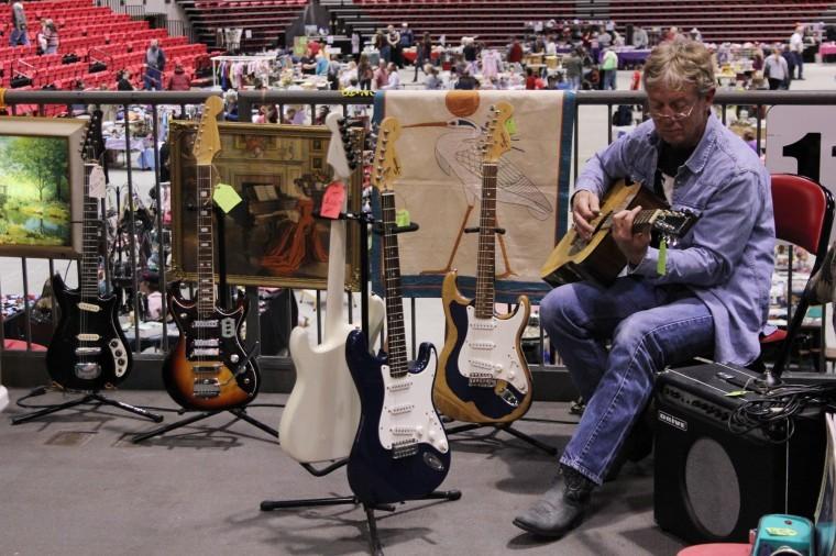 Steve Briarton, 55, of Monroe Center plays guitar at his stall April 22, 2012 at the Colossal Clean Sweep in the Convocation Center.