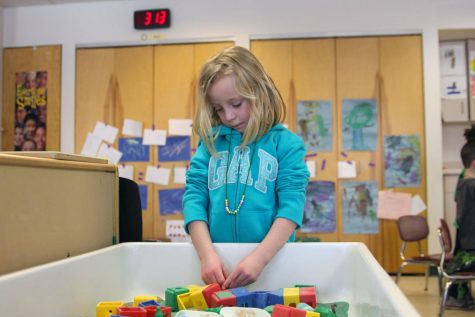 Sadie Lang, 4, of Sycamore, plays at the sand table Friday at Campus Child Care. The center “predominately” serves student families, said Christine Kipp, director of NIU Campus Child Care.
