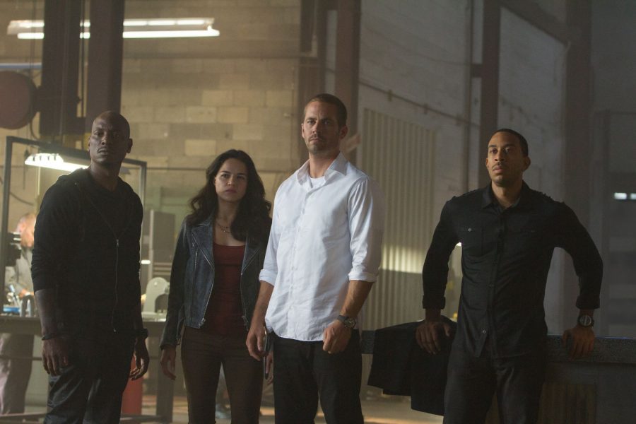 “Furious 7,” starring (from left) Tyrese Gibson, Michelle Rodriguez and Paul Walker, is fueled with action and humor, making viewing it a memorable experience. “Furious 7” was released Friday.