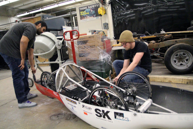 (From left) Saajan Pater, senior industrial management technology major, assists senior technology major, Tom Swanberg, test the cam shaft design of the supermileage vehicle Jan. 22, 2014 in the basement of Still Gym. They estimated the craft would get 1,600 miles to the gallon. They achieved 1,173 miles per gallon in 2013, while their goal for 2014 was 2,000 miles per gallon.