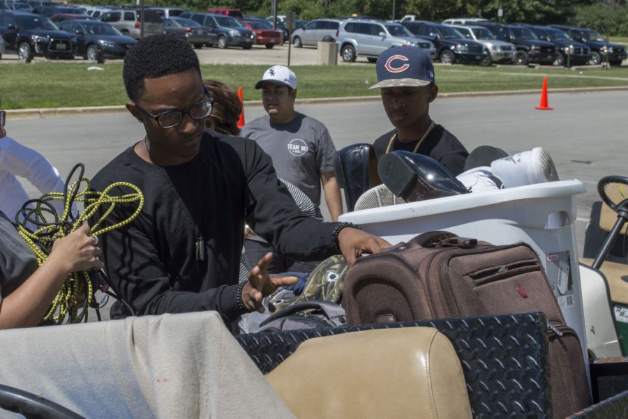 Freshman business administration major Christopher Harris loads his belongings on to a cart while moving into Stevenson Hall on Friday. More than 5,000 students have been credited for MAP grant funding, despite a budget impasse.