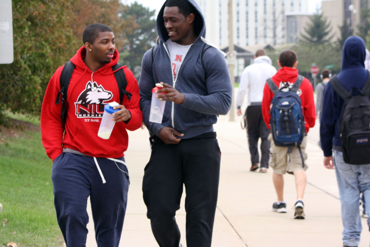 Freshman psychology major Jason Betts Jr. (left) and sophomore English major Jalen Olajuwon walk down Lucinda Avenue on April 28, 2014, following a workout at the Recreation Center.
