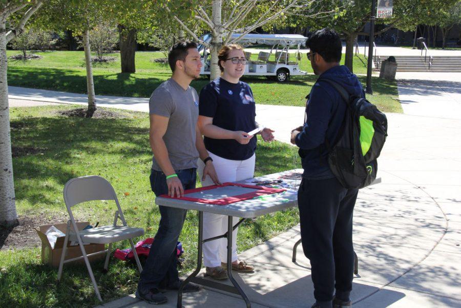 Michael Agro (left), Student Association director of Athletics, and Jackie Keith, interim director of Greek Affairs, talks to Shiza Ratakomda, senior mechanical engineering student, about SA events for National Hazing Prevention Week on Monday in the Martin Luther King Jr. Commons.