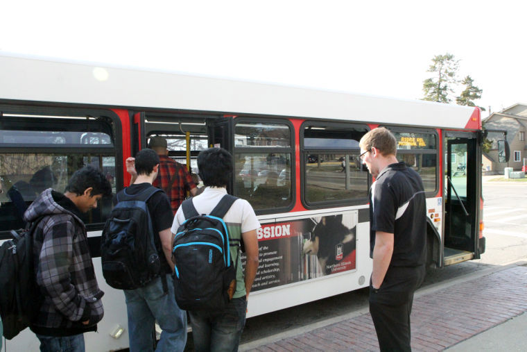 Students enter a Huskie Bus on April 10, 2014, in front of the Holmes Student Center.