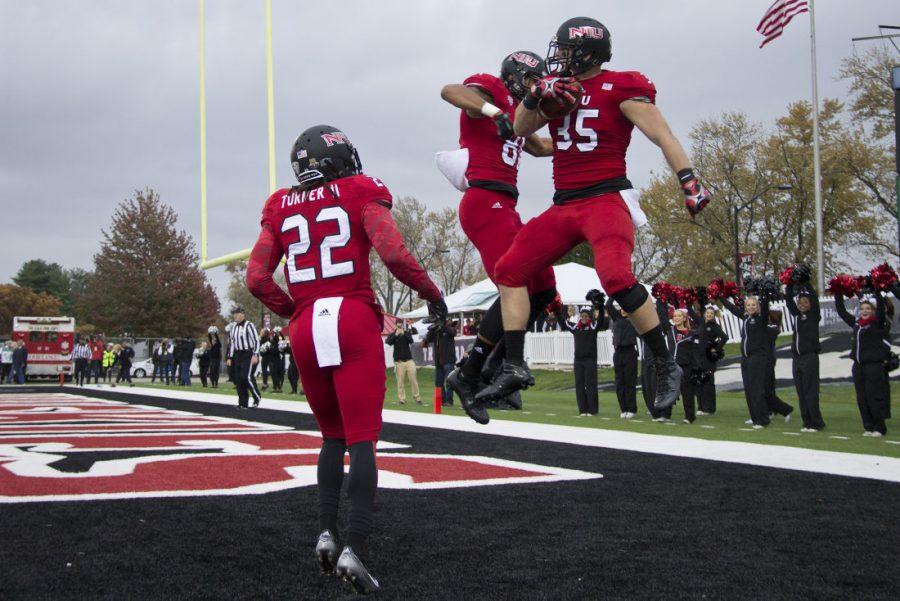 Shane Wimann (35) celebrates a touchdown with fellow receivers Clayton Glasper (81) and Aregeros Turner (22). The Huskies caught four touchdowns in their 49-21 victory over Eastern Michigan on Saturday.