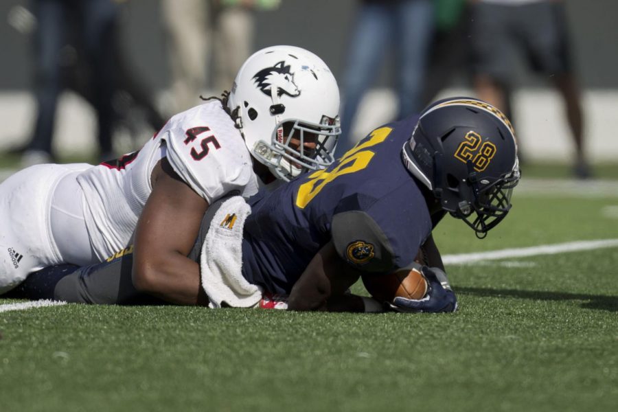 Boomer Mays, a redshirt Senior from Lawrence, Kansas, tackles a Murray State player. The Huskies held Murray State to 2.6 yards per rush in their 57-26 win over the Racers.