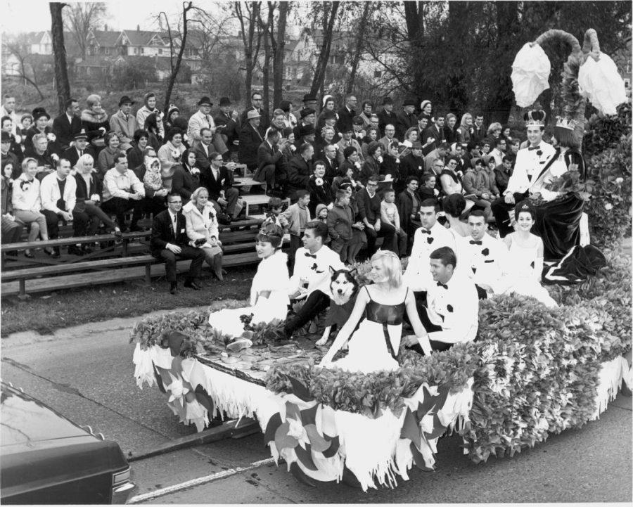Homecoming royalty rides along a street in DeKalb during the first Homecoming in commemoration for the newly-built Huskie Stadium on Nov. 6, 1965. Senior Jim Kelly was crowned Homecoming King and senior Sue Craumer was crowned Homecoming Queen.