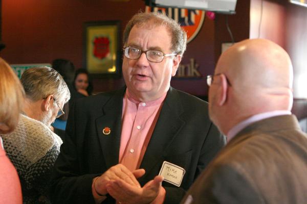 Alumnus Mike Korcek (left) speaks with Phil Kadner in 2009.