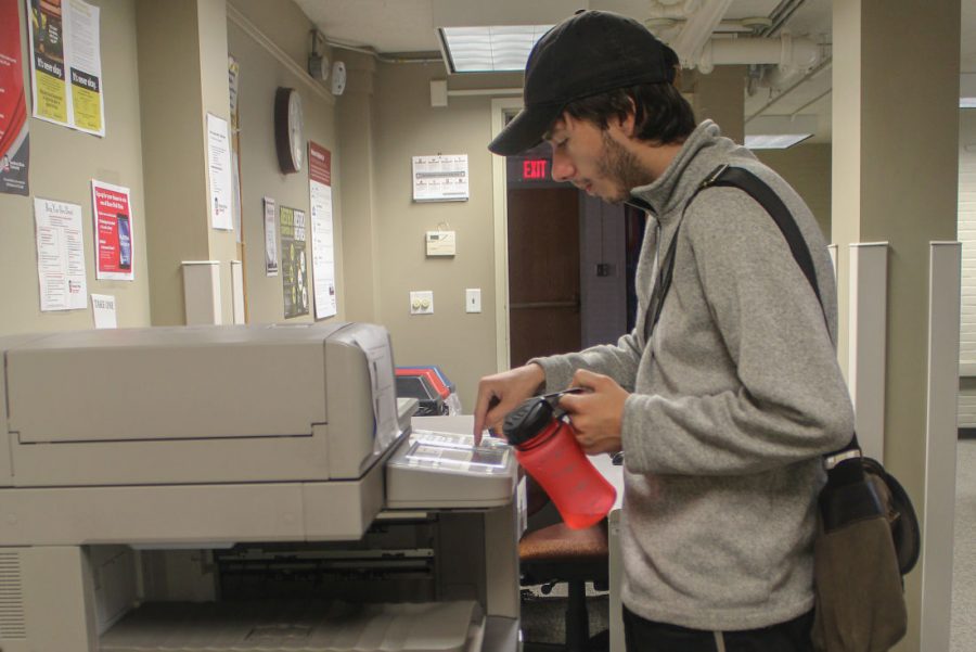 David Sadkowski, sophomore theatre arts design and technology, uses the Anywhere Printer located in the Neptune computer lab.