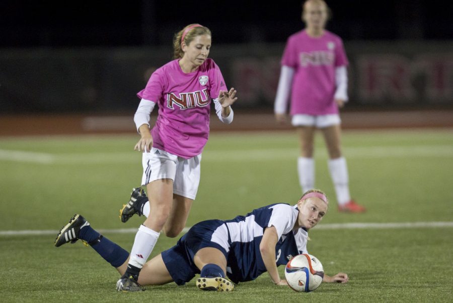Freshman forward Kate Sanfilippo hops over a defender in an Oct. 9 game against Akron. The Zips went on to win the game 2-1, giving the Huskies a four-game losing streak.