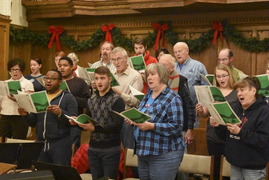 Members of the First United Methodist Church choir practice music in the main sanctuary of the church Wednesday evening.