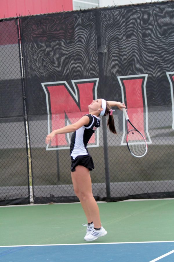 Evelyn Youel serves against Western Michigan on April 12. The Huskies would fall to the Broncos 4-3.