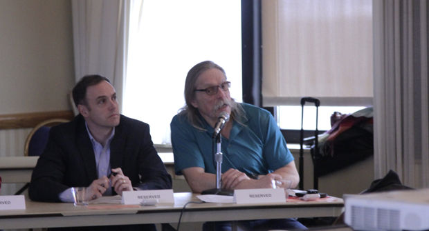 Matt Streb, administrative task force co-chair, (left) and George Slotsve, academic task force co-chair, discuss the progress of NIU’s program prioritization efforts at the Faculty Senate meeting Wednesday in the Holmes Student Center, Sky Room.