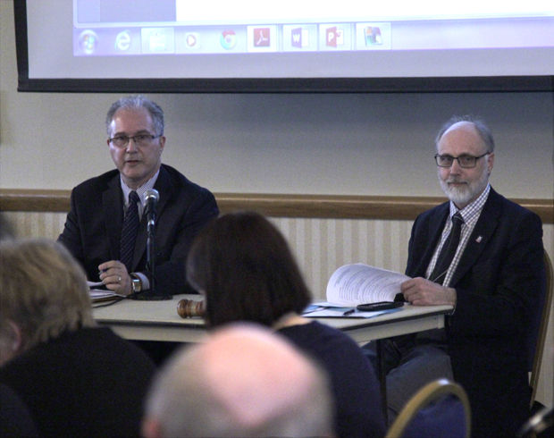 NIU President Doug Baker (left) and Greg Long, executive secretary of University Council, discuss the current budget issues NIU is facing due to the continued state budget impasse Wednesday at a University Council meeting in the Holmes Student Center, Sky Room.