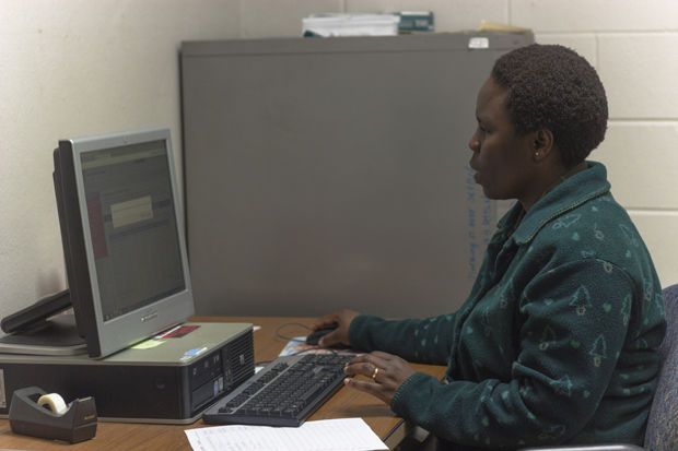Swahili Teaching Assistant Mary Okeyo works in an office in DuSable Hall on Wednesday. Okeyo is raising money to bring her husband from Tanzania to her graduation at NIU.