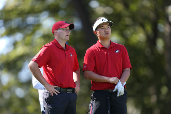 Junior Joo-young Lee speaks with Coach Andrew Frame at the 2015 Northern Intercollegiate in Sugar Grove.