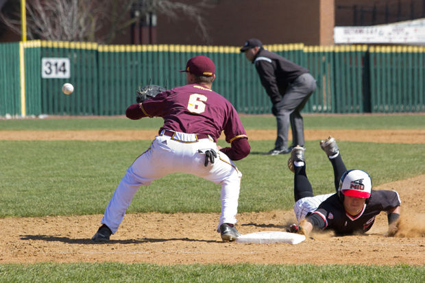 Junior outfielder Jason Gasser dives back to first base in an April 8 game against Central Michigan University. The Huskies have gone 6-5 since starting MAC play.