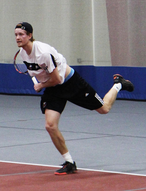 Sophomore Tom Hjertonsson returns a volley in a match against Eastern Illinois University on Jan. 30. Hjertonsson won his singles match on Saturday, but the Huskies lost to Ball State overall by a score of 4-3.
