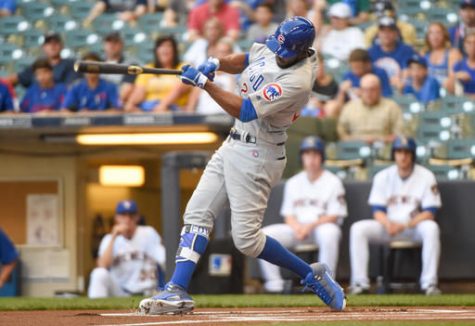 Chicago Cubs' Dexter Fowler swings on a lead-off home run off Milwaukee Brewers starting pitcher Jimmy Nelson during the first inning of a baseball game Friday, July 22, 2016, in Milwaukee.