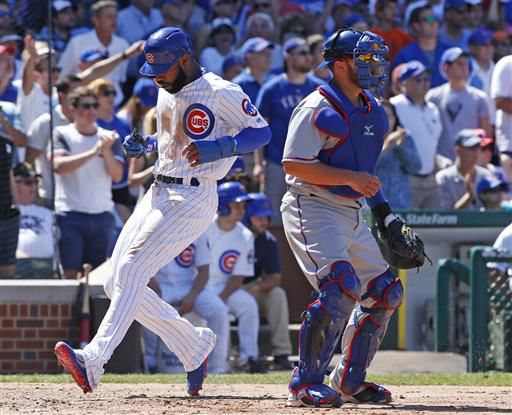 Chicago Cubs outfielder Jason Heyward (left) scores a run in Saturday’s game against the Texas Rangers. Heyward went 0-3 with a walk and a strikeout in the game as the Cubs fought Texas off for a 3-1 win, their third straight victory following a four-game skid.